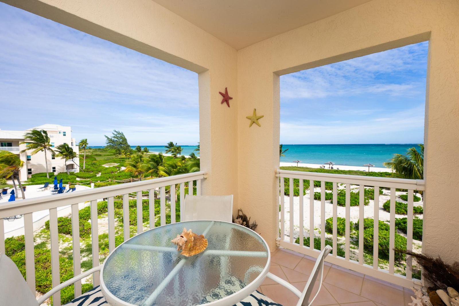 The private ocean facing balcony with table and chairs